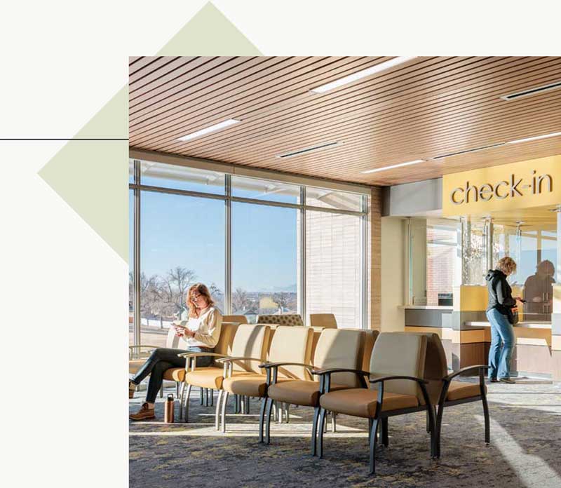 Two people at the check-in lobby of a healthcare facility