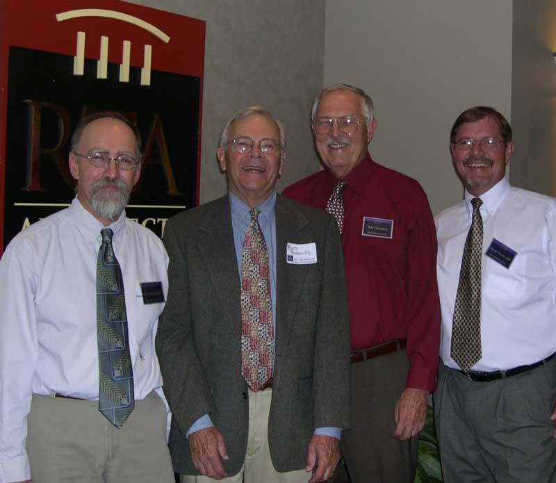 Dave, Bud, and Randy posing in front of the RTA logo