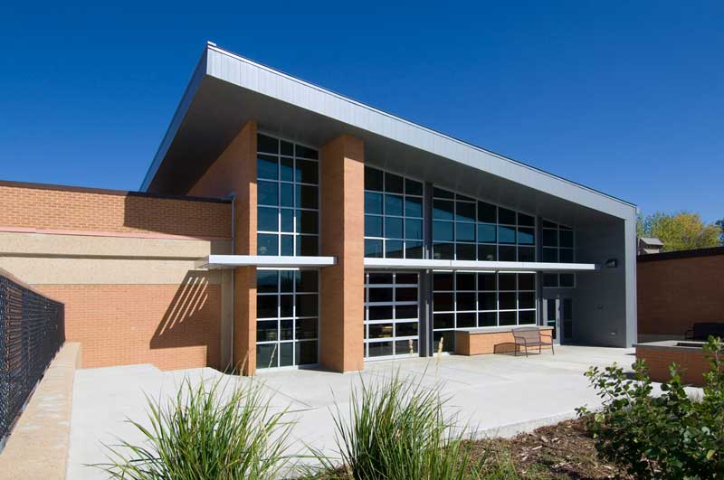 Front entrance to Arapahoe Ridge High School featuring a triangular sloped roof and an all glass wall.