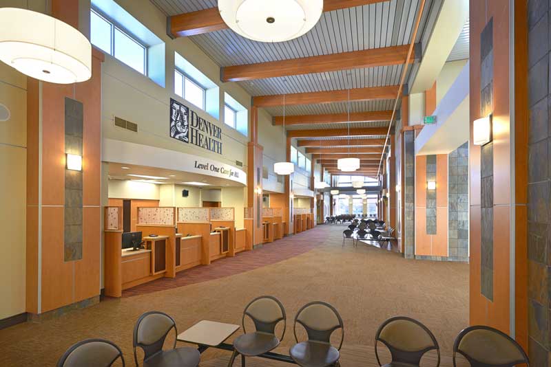 Interior view of the Southwest Clinic waiting area, featuring a spacious, modern design with comfortable seating, natural light streaming through large windows, and warm, neutral tones creating a welcoming atmosphere.