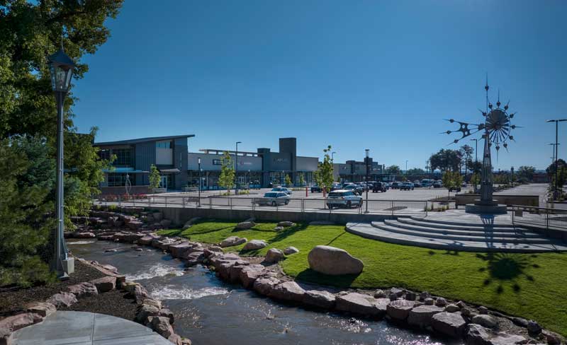 Aerial view of Creekwalk Shopping Center, showcasing a modern retail development with a mix of storefronts, parking areas, and landscaped outdoor spaces. The design emphasizes accessibility, convenience, and a vibrant shopping experience.