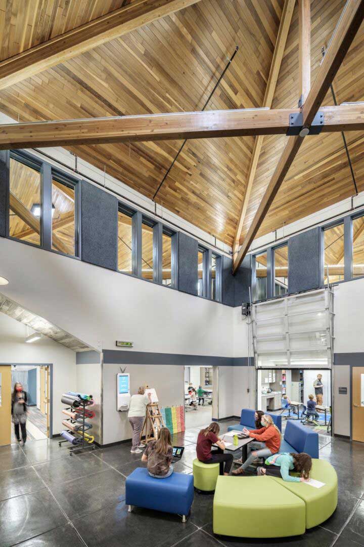 Interior view of Lake City School's art and library space, featuring an open layout with bright natural light, wooden accents, and bookshelves lining the walls. The space is designed to foster creativity and learning in a warm, inviting environment.