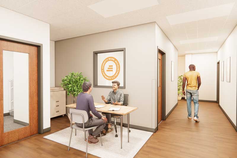 Interior view of the STEP Colorado Springs reception area, featuring a modern design with a sleek reception desk, comfortable seating, and branding elements displayed on the wall. Warm lighting and a neutral color palette create a welcoming and professional atmosphere.