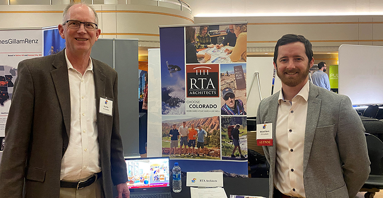paul reu and mitchell starrs standing in front of the rta booth at a career fair