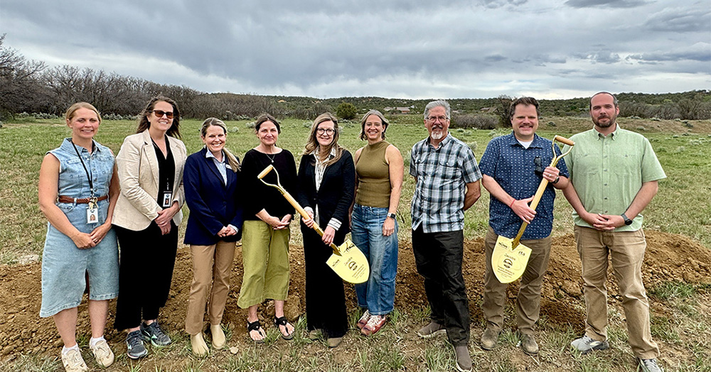 a group of people with shovels at the groundbreaking ceremony
