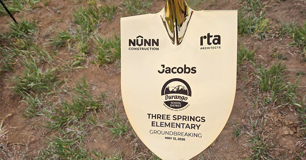 ceremonial shovel with project name, district logo, architect logo, and contractor logo printed on it
