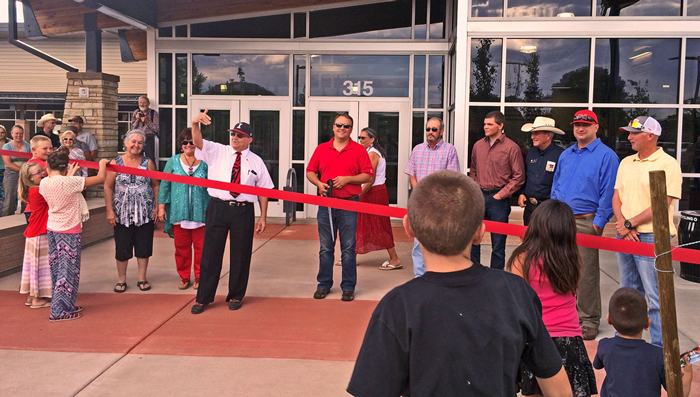 a crowd gathered in front of the high school for the ribbon cutting