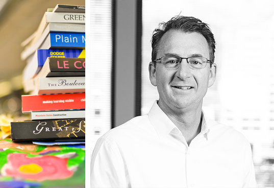 Stack of books and head shot of Doug Abernethy